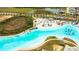 Aerial view featuring community lagoon, white sand beach, and inviting blue waters at 8261 Ivy Stark Blvd, Wesley Chapel, FL 33545