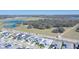 An aerial showcases a community near green spaces and lakes with houses lining the roadways at 8261 Ivy Stark Blvd, Wesley Chapel, FL 33545