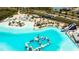 Aerial view of the turquoise community pool complete with an amazing beach and slide at 8261 Ivy Stark Blvd, Wesley Chapel, FL 33545