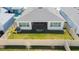 Backyard featuring a well-maintained lawn, a screened-in porch and a fenced perimeter at 8261 Ivy Stark Blvd, Wesley Chapel, FL 33545