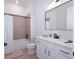 Clean bathroom with a bathtub and shower, and a vanity with a sleek white countertop at 8261 Ivy Stark Blvd, Wesley Chapel, FL 33545