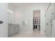 Elegant bathroom with double sinks, granite countertop and access to a walk-in closet at 8261 Ivy Stark Blvd, Wesley Chapel, FL 33545