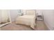 Cozy bedroom features a comfortable bed with beige bedding and matching bedside tables with drawer and storage at 8261 Ivy Stark Blvd, Wesley Chapel, FL 33545
