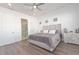 A well lit bedroom with laminate wood flooring, a walk in shower, and neutral decor at 8261 Ivy Stark Blvd, Wesley Chapel, FL 33545