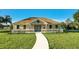 Charming clubhouse featuring a welcoming porch, white railings, and a well-manicured lawn at 8261 Ivy Stark Blvd, Wesley Chapel, FL 33545