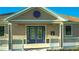 Close-up of the clubhouse entrance, highlighting the blue double doors and attractive architectural details at 8261 Ivy Stark Blvd, Wesley Chapel, FL 33545