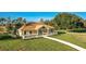 Aerial view showcasing the clubhouse with a covered porch and lush green lawn, ideal for relaxation at 8261 Ivy Stark Blvd, Wesley Chapel, FL 33545