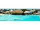 A beautiful turquoise community pool with a swim-up bar and thatched roof at 8261 Ivy Stark Blvd, Wesley Chapel, FL 33545