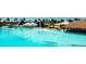 Expansive turquoise community pool with beach area, thatched bar, and slide at 8261 Ivy Stark Blvd, Wesley Chapel, FL 33545