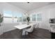 Dining area featuring a stylish marble dining table with modern lighting and window views at 8261 Ivy Stark Blvd, Wesley Chapel, FL 33545