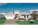 Charming single-story home with a well-manicured lawn, attached garage, and beautiful landscaping at 8261 Ivy Stark Blvd, Wesley Chapel, FL 33545