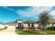 Charming single-story home with a well-manicured lawn, attached garage, and beautiful landscaping at 8261 Ivy Stark Blvd, Wesley Chapel, FL 33545