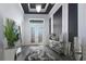 Elegant foyer with decorative ceiling, stylish mirrors, and a modern console table at 8261 Ivy Stark Blvd, Wesley Chapel, FL 33545