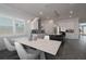 Spacious kitchen and dining area with modern lighting, stainless steel appliances, and ample counter space at 8261 Ivy Stark Blvd, Wesley Chapel, FL 33545