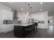 An open kitchen featuring white cabinets, a stainless steel refrigerator, and a granite topped island at 8261 Ivy Stark Blvd, Wesley Chapel, FL 33545