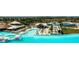 An aerial view captures the lagoon amenity with bar, beach, loungers and beautiful blue water at 8261 Ivy Stark Blvd, Wesley Chapel, FL 33545