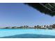 Beautiful view of the lagoon featuring clear blue water and a distant shoreline with palm trees and thatched umbrellas at 8261 Ivy Stark Blvd, Wesley Chapel, FL 33545
