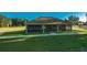 Exterior shot of a recreation room with a large grassy field, providing plenty of space for activities at 8261 Ivy Stark Blvd, Wesley Chapel, FL 33545