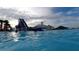 View of community water park with water slide, clubhouse, tiki hut, and in-water guests at 8261 Ivy Stark Blvd, Wesley Chapel, FL 33545