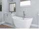 Bathroom featuring a modern white tub, floating faucet, and white vanity at 8308 Jackson Springs Rd, Tampa, FL 33615