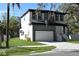 Stylish two-story home with a blend of white and gray, complemented by a well-kept lawn and inviting entry at 8308 Jackson Springs Rd, Tampa, FL 33615