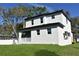 Two-story home with white exterior, black trim, and green lawn at 8308 Jackson Springs Rd, Tampa, FL 33615