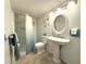 Well-maintained bathroom featuring a pedestal sink, oval mirror, and a shower with glass doors at 865 Virginia Ct # 106, Dunedin, FL 34698