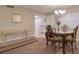 Charming dining room with an ornate table, four chairs, and open access to the kitchen at 865 Virginia Ct # 106, Dunedin, FL 34698