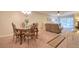 Inviting dining area with ornate table set, flowing into a comfortable living room at 865 Virginia Ct # 106, Dunedin, FL 34698