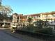 A three-story condo building with covered parking and landscaping features inviting balconies at 865 Virginia Ct # 106, Dunedin, FL 34698