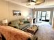 Bright living room featuring comfortable seating, a ceiling fan, and a sliding glass door to a screened patio at 865 Virginia Ct # 106, Dunedin, FL 34698