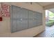 Image of wall-mounted mailboxes with unit numbers at a residential complex with painted white walls at 865 Virginia Ct # 106, Dunedin, FL 34698