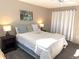 Serene main bedroom with soft carpet, natural light, and decorative accents create a tranquil retreat at 865 Virginia Ct # 106, Dunedin, FL 34698
