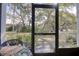 Screened patio area, perfect for enjoying outdoor views of the landscaped yard and mature trees at 865 Virginia Ct # 106, Dunedin, FL 34698