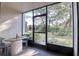 Covered patio with outdoor seating overlooks a meticulously landscaped yard and mature trees at 865 Virginia Ct # 106, Dunedin, FL 34698