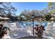 Lounge chairs around a pool, set against the backdrop of lush foliage, offering relaxation and enjoyment at 865 Virginia Ct # 106, Dunedin, FL 34698