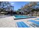 Picture of a large pool surrounded by lounge chairs on a sunny day, perfect for unwinding at 865 Virginia Ct # 106, Dunedin, FL 34698
