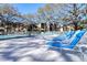 Inviting swimming pool with lounge chairs, perfect for relaxation and enjoying the beautiful surroundings at 865 Virginia Ct # 106, Dunedin, FL 34698