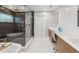 Bathroom featuring walk-in shower, a soaking tub, and a double vanity with designer fixtures and hardware at 8693 15Th N St, St Petersburg, FL 33702