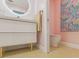 Bathroom featuring pink walls, updated fixtures, vanity, mirror and toilet at 8693 15Th N St, St Petersburg, FL 33702