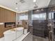 Stunning bathroom featuring a freestanding tub, fireplace, and a glass enclosed shower with dual shower heads at 8693 15Th N St, St Petersburg, FL 33702