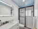 Bathroom with a marble countertop sink and updated tiled shower and modern finishes at 8693 15Th N St, St Petersburg, FL 33702