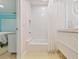 Modern bathroom features white subway tile, a tub and white shower curtain at 8693 15Th N St, St Petersburg, FL 33702