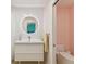 Bathroom featuring modern round mirror and white vanity with updated fixtures at 8693 15Th N St, St Petersburg, FL 33702