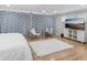 A bedroom featuring a plush rug, curtains, and a television on a white dresser at 8693 15Th N St, St Petersburg, FL 33702