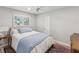 Cozy bedroom featuring a comfortable bed, ceiling fan, and natural light from the window at 8693 15Th N St, St Petersburg, FL 33702