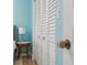 Bright bedroom with blue walls with a closet with shutter doors and vintage doorknob at 8693 15Th N St, St Petersburg, FL 33702
