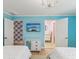 Bright bedroom with two beds, chandelier, TV, and ensuite bathroom and closet at 8693 15Th N St, St Petersburg, FL 33702