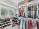 Elegant walk-in closet featuring ample storage, custom shelving, and designer lighting at 8693 15Th N St, St Petersburg, FL 33702