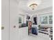 Well-lit walk-in closet with custom shelving, drawers, and a sparkling chandelier at 8693 15Th N St, St Petersburg, FL 33702